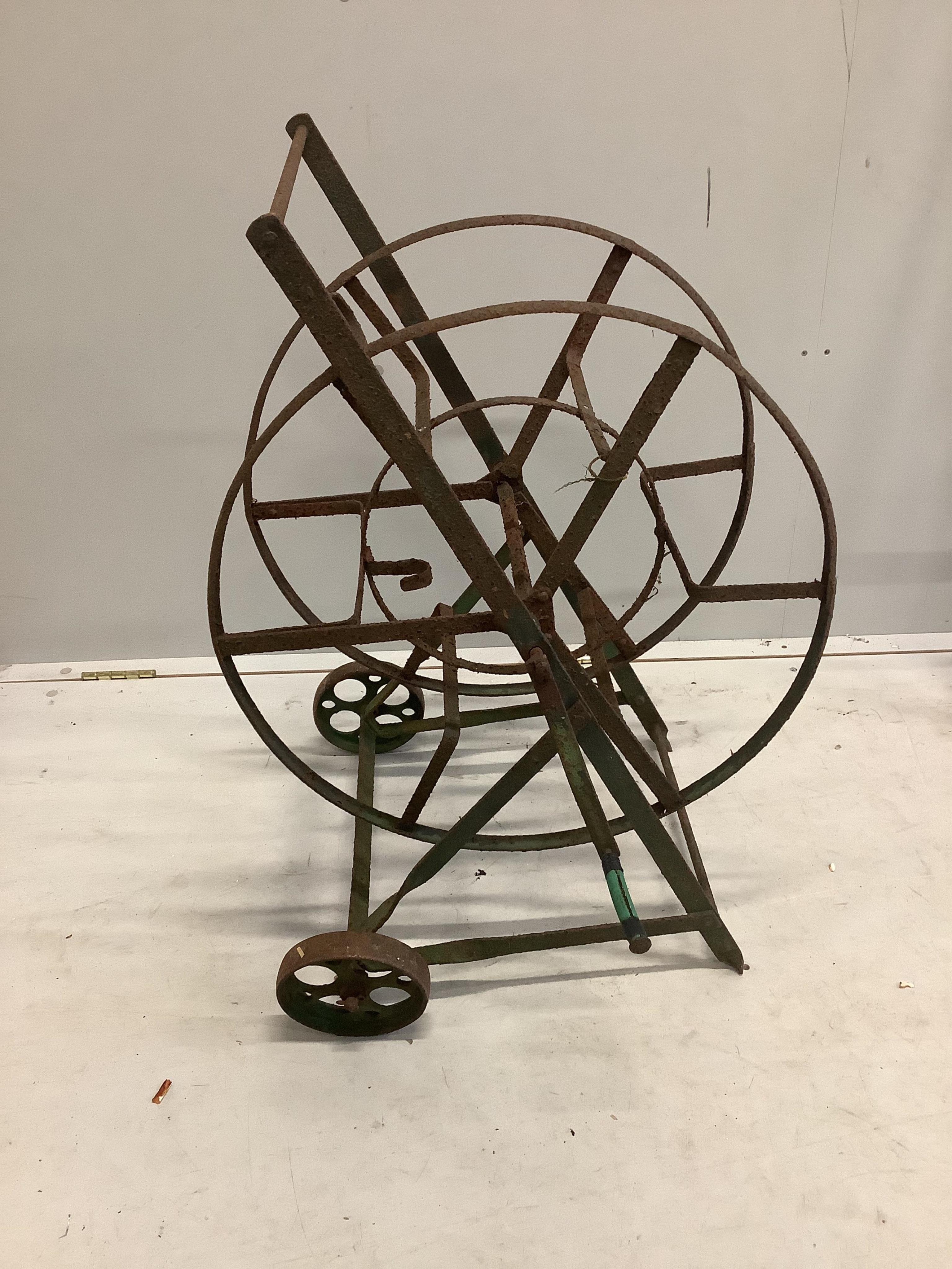 A wrought iron boot scraper, height 122cm together with a hose reel stand. Condition - poor to fair